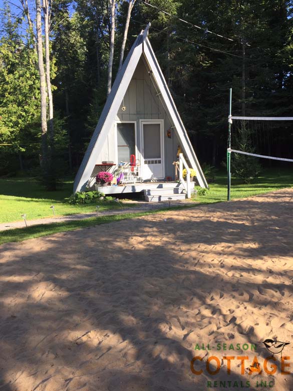 A-frame Bunkie is behind the cottage, beside beach volleyball court.  Windows on both sides provide great air flow during summer.